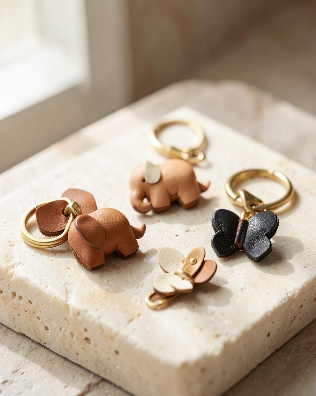 Leather charms and keychains on a stone surface